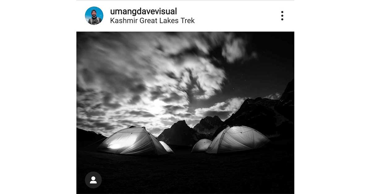 Black and white photo of clouds and tents