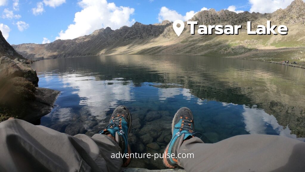 Trekker enjoying surreal views of Tarsar Lake in Kashmir.