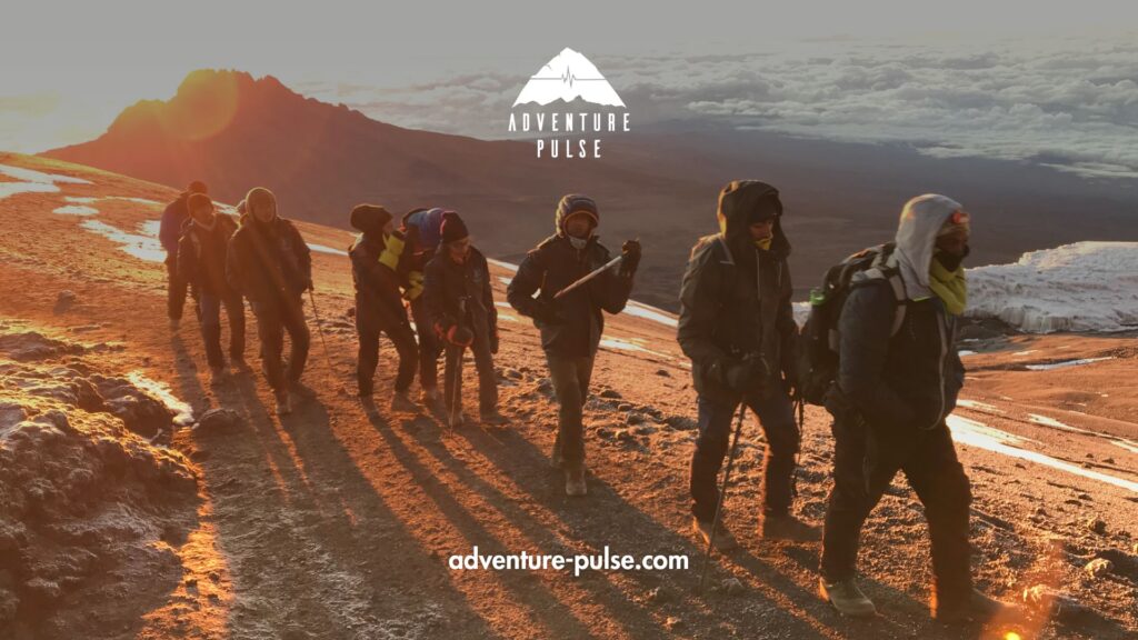 Trekkers approaching the summit of Kilimanjaro during sunrise.