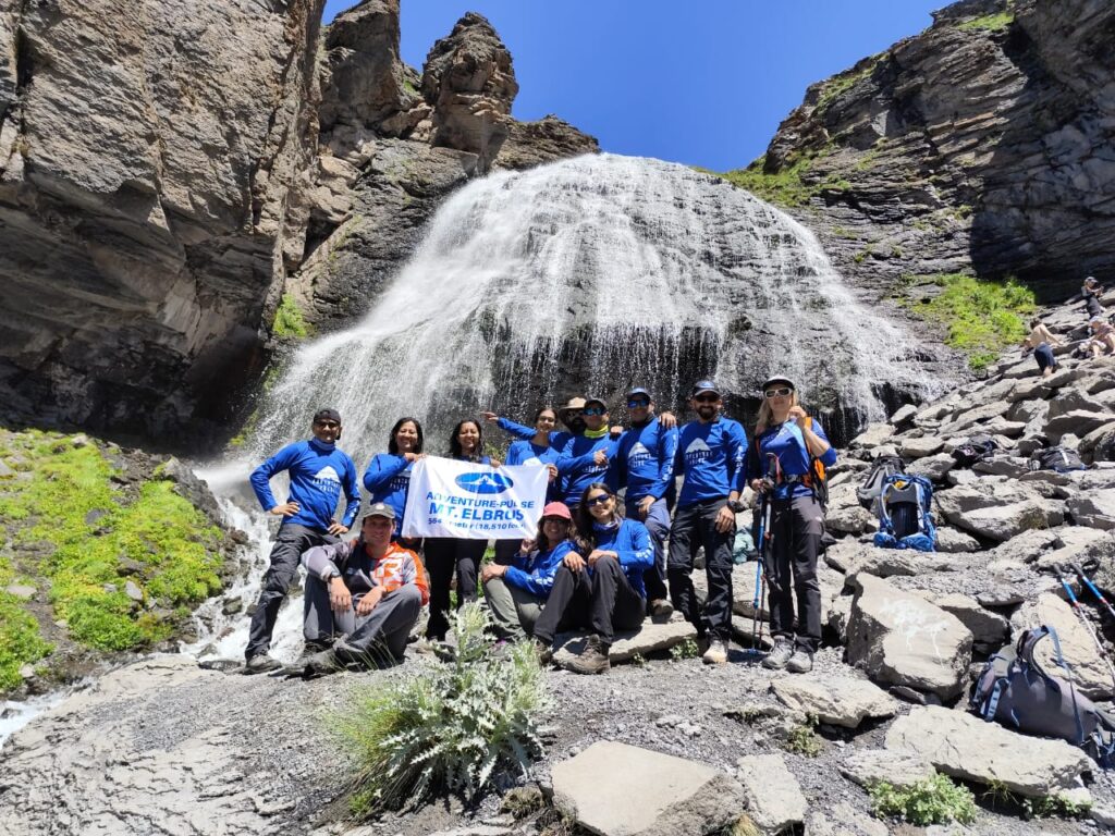 Trekkers, Hikers at a Waterfall in Russia, Mount Elbrus