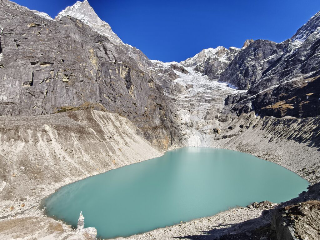 A glacial lake surrounded by snow capped mountains