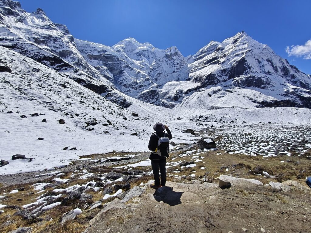 A trekker overlooking a snow covered mountain range.
