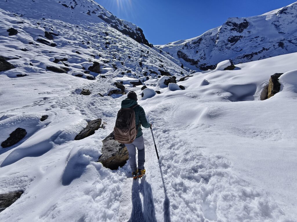 A climber walking through snow in Nepal