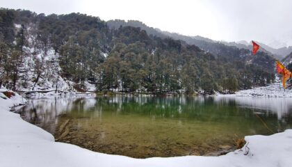 Dodital Lake surrounded by snow cover landscape and trees
