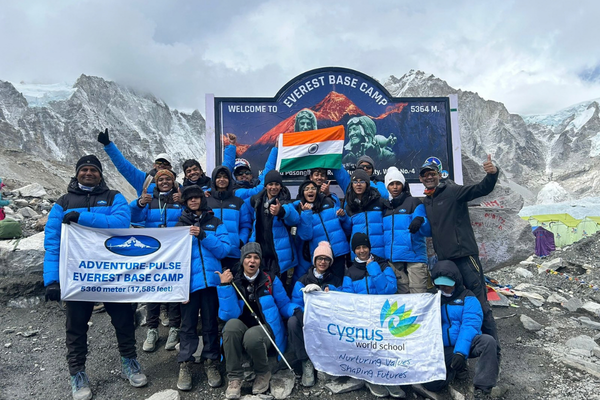 Trekkers celebrating at Everest Base Camp during the EBC trek in Nepal